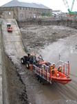 SX26448 Big and small lifeboat tracktors going up slipway.jpg